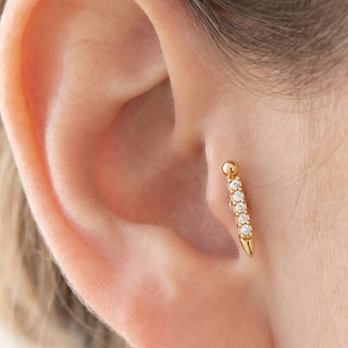 Golden Tragus Piercing – selection on linen